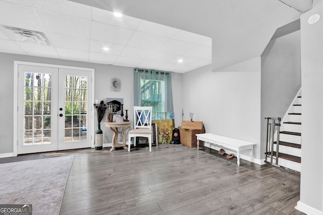 home office with wood finished floors, french doors, baseboards, and a drop ceiling