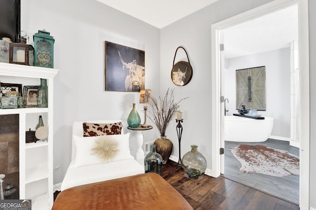 sitting room featuring wood finished floors and baseboards