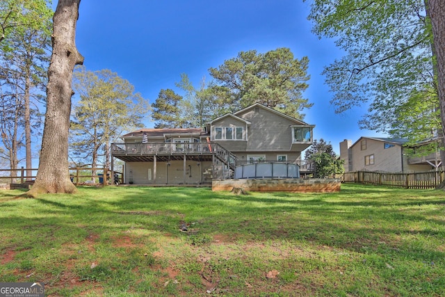 rear view of property featuring a deck and stairway