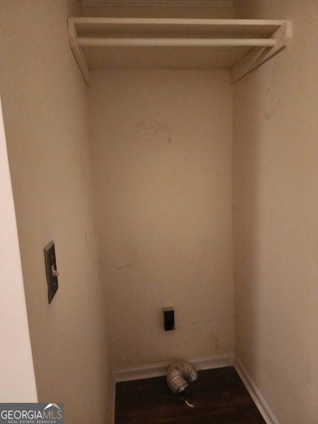 clothes washing area featuring laundry area and baseboards