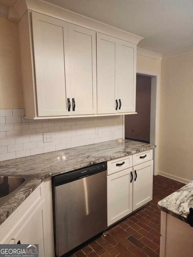 kitchen with tasteful backsplash, light stone counters, brick floor, dishwasher, and crown molding
