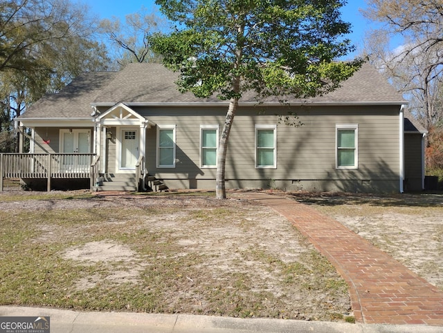 view of front of house featuring covered porch, a shingled roof, and crawl space