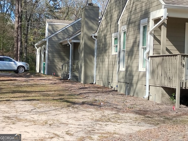 view of side of home with a chimney