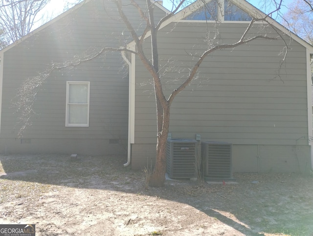 view of side of property with central air condition unit and crawl space