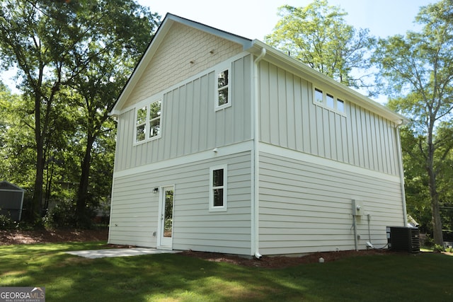 113 Sharp St, Bremen, GA 30110 - rear view of property featuring board and batten siding, a lawn, a patio, and cooling unit
