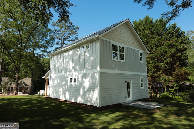 113 Sharp St, Bremen, GA 30110 - view of side of property featuring board and batten siding, a lawn, and a patio