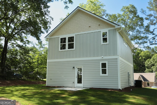 113 Sharp St, Bremen, GA 30110 - rear view of house with board and batten siding, a lawn, and central air condition unit