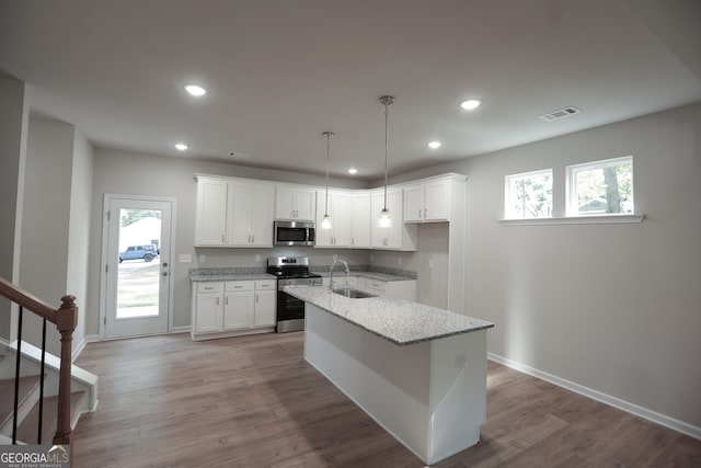 113 Sharp St, Bremen, GA 30110 - kitchen with appliances with stainless steel finishes, a sink, recessed lighting, white cabinets, and light stone counters