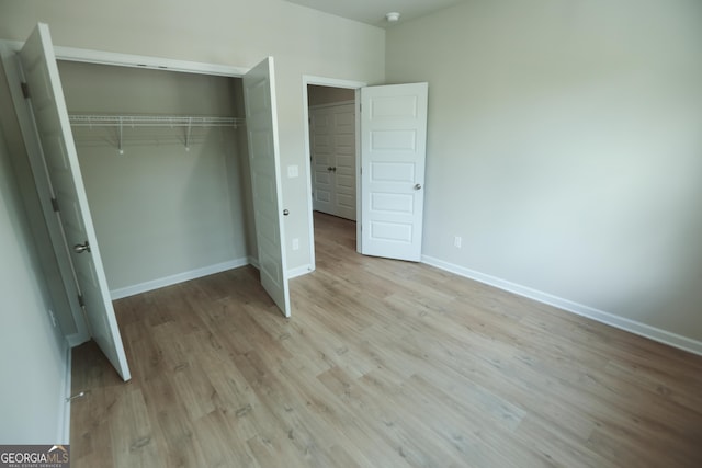 113 Sharp St, Bremen, GA 30110 - unfurnished bedroom featuring a closet, light wood finished floors, and baseboards