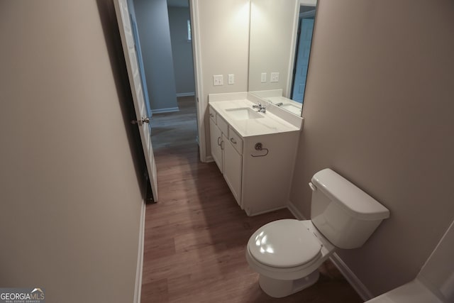 113 Sharp St, Bremen, GA 30110 - bathroom with baseboards, toilet, wood finished floors, and vanity