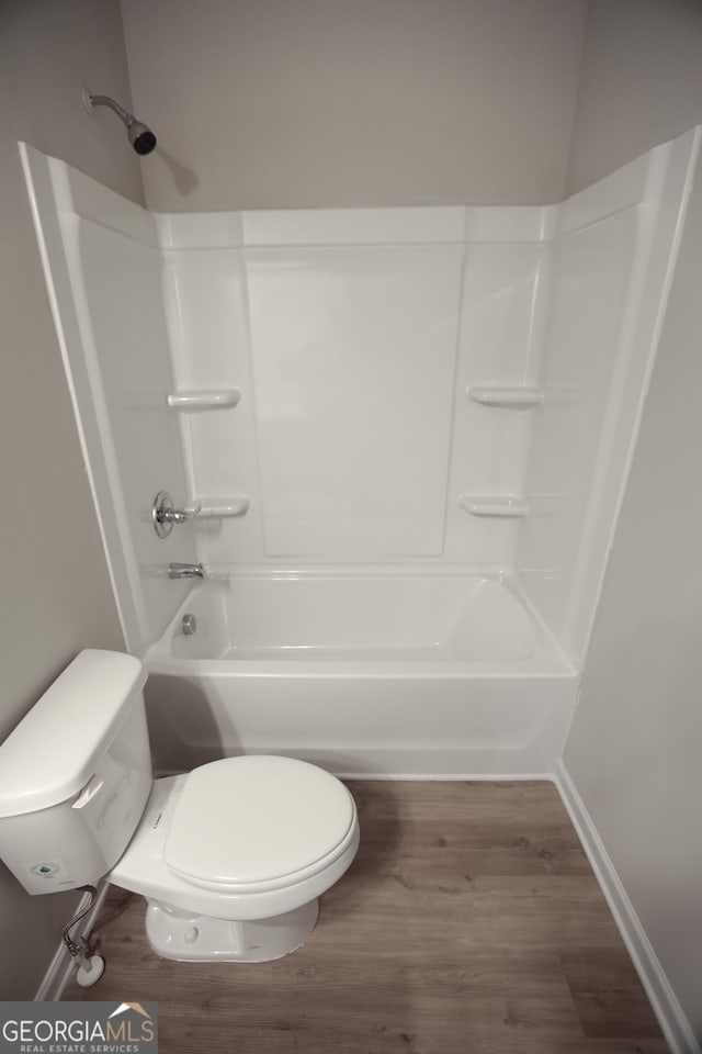 113 Sharp St, Bremen, GA 30110 - bathroom featuring toilet, wood finished floors, shower / washtub combination, and baseboards