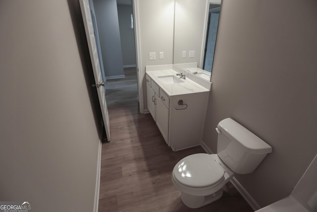 113 Sharp St, Bremen, GA 30110 - bathroom with baseboards, toilet, wood finished floors, and vanity