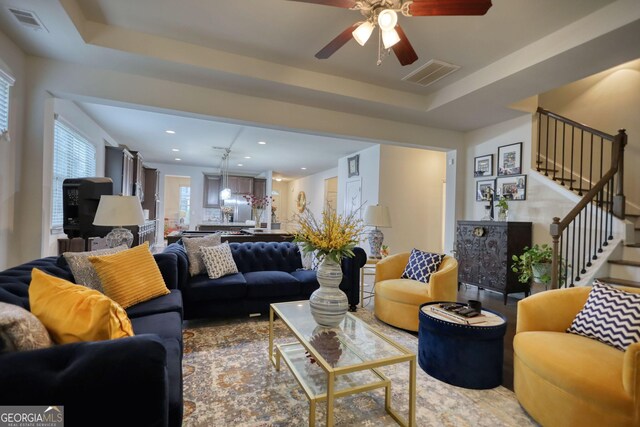 164 Madison Grace Ave, Mcdonough, GA 30252 - living area featuring visible vents, stairway, a ceiling fan, and a raised ceiling