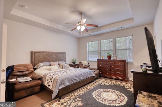 164 Madison Grace Ave, Mcdonough, GA 30252 - bedroom with visible vents, ceiling fan, wood finished floors, and a raised ceiling
