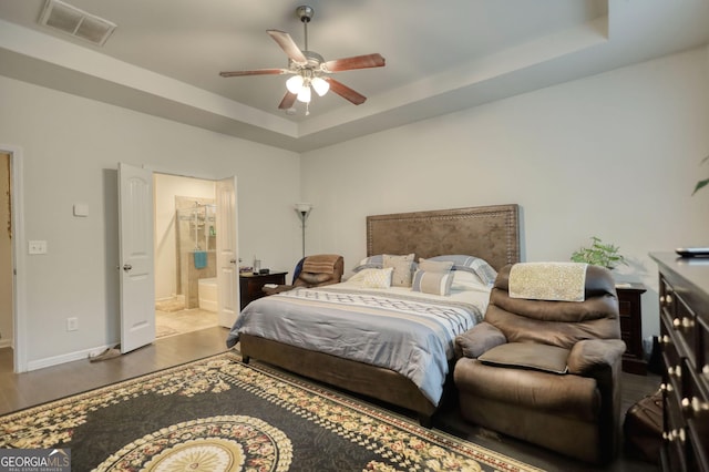 164 Madison Grace Ave, Mcdonough, GA 30252 - bedroom with a tray ceiling, wood finished floors, ensuite bath, baseboards, and visible vents