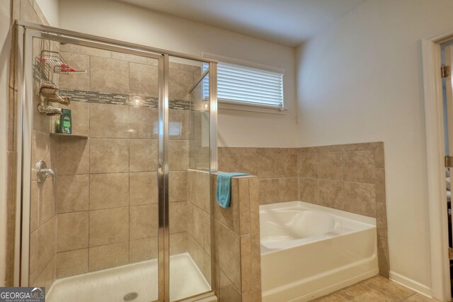 164 Madison Grace Ave, Mcdonough, GA 30252 - full bathroom with a shower stall, tile patterned floors, and a garden tub