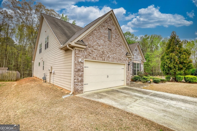 164 Madison Grace Ave, Mcdonough, GA 30252 - view of side of home with concrete driveway, fence, an attached garage, brick siding, and a shingled roof