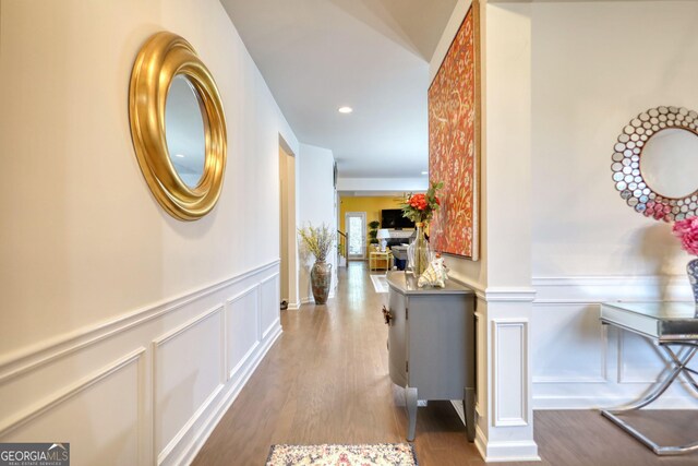 164 Madison Grace Ave, Mcdonough, GA 30252 - hallway featuring a wainscoted wall, recessed lighting, wood finished floors, and a decorative wall