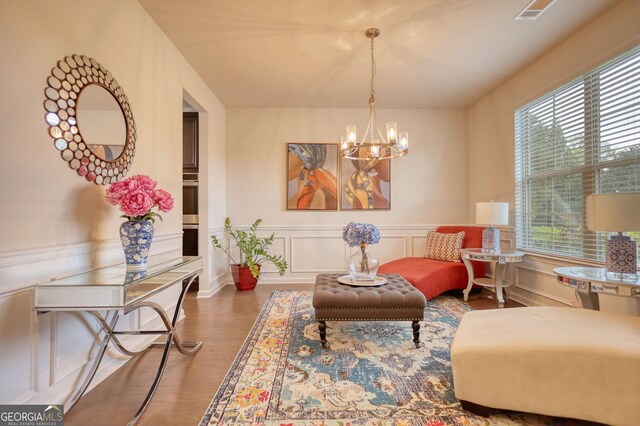 164 Madison Grace Ave, Mcdonough, GA 30252 - sitting room with an inviting chandelier, a decorative wall, plenty of natural light, and wood finished floors