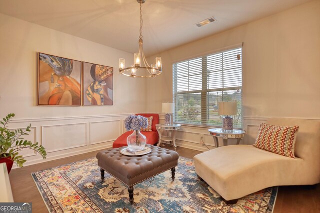 164 Madison Grace Ave, Mcdonough, GA 30252 - sitting room with a wainscoted wall, a notable chandelier, wood finished floors, a decorative wall, and visible vents