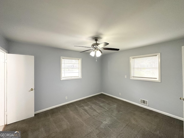 2087 John Wesley Ct, Decatur, GA 30035 - empty room featuring baseboards, visible vents, dark colored carpet, and ceiling fan