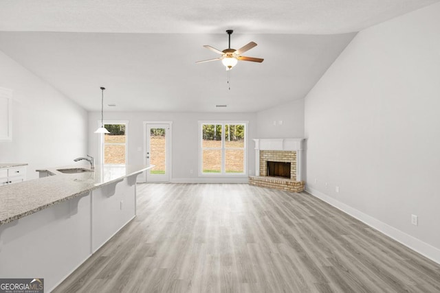 357 Liberty Hill Rd Unit 18, Hartwell, GA 30643 - unfurnished living room featuring a ceiling fan, a sink, lofted ceiling, and light wood-style flooring