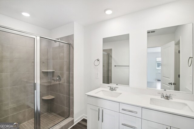 full bath featuring a sink and a shower stall