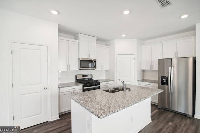 kitchen featuring dark wood-style floors, white cabinets, a sink, and stainless steel appliances