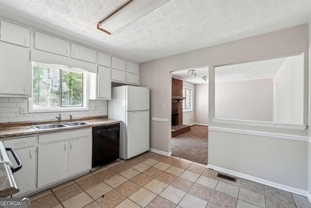 1360 Cypress Ridge Cir, Stone Mountain, GA 30083 - kitchen with backsplash, a sink, visible vents, freestanding refrigerator, and black dishwasher