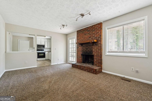 1360 Cypress Ridge Cir, Stone Mountain, GA 30083 - unfurnished living room with light carpet, a wealth of natural light, visible vents, and a brick fireplace