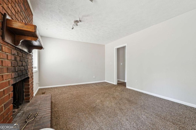 1360 Cypress Ridge Cir, Stone Mountain, GA 30083 - unfurnished living room with baseboards, a textured ceiling, carpet, and a brick fireplace