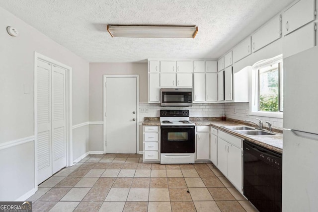 1360 Cypress Ridge Cir, Stone Mountain, GA 30083 - kitchen with stainless steel microwave, a sink, freestanding refrigerator, black dishwasher, and range with electric cooktop