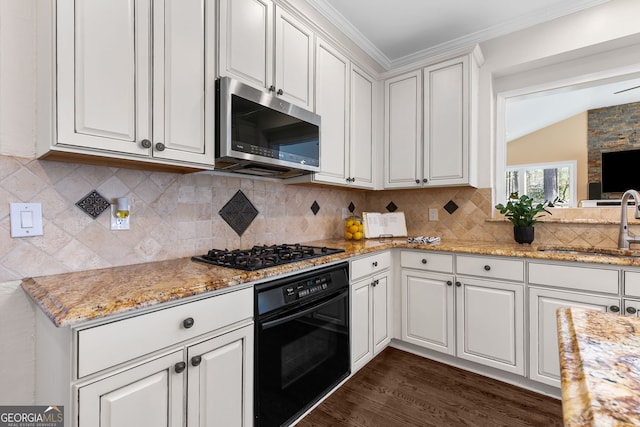 kitchen featuring dark wood-style flooring, crown molding, white cabinetry, a sink, and black appliances