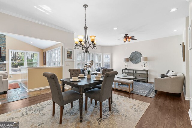 dining room featuring crown molding, wood finished floors, baseboards, ceiling fan with notable chandelier, and recessed lighting
