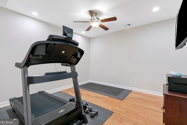 workout area featuring a ceiling fan, wood finished floors, baseboards, and visible vents