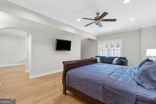 bedroom featuring recessed lighting, ornamental molding, baseboards, arched walkways, and light wood finished floors