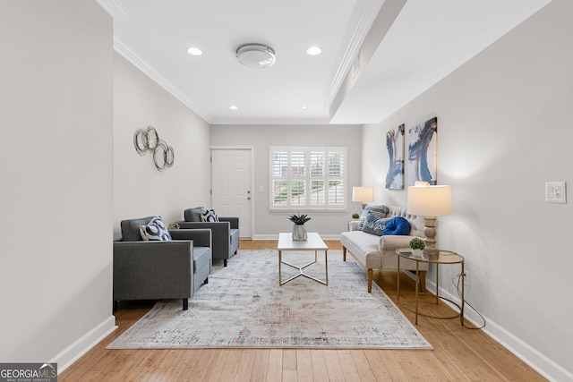 living room featuring ornamental molding, baseboards, and wood finished floors