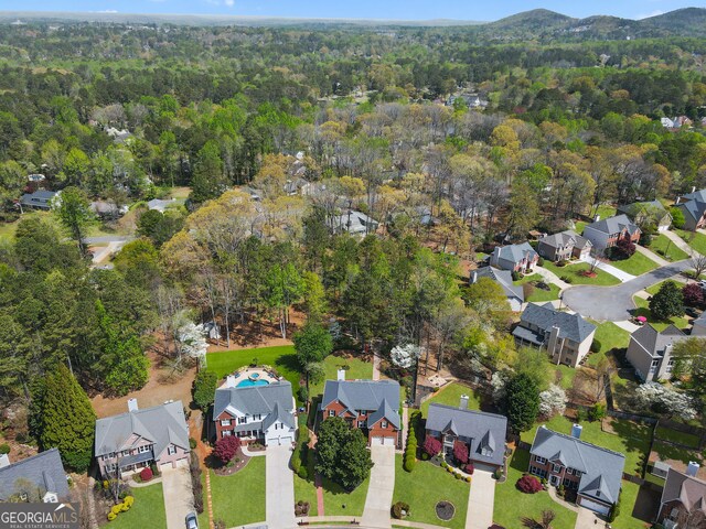 birds eye view of property with a view of trees and a residential view