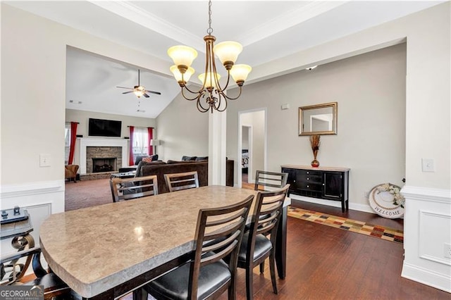 95 Summerlyn Dr, Hiram, GA 30141 - dining area with ceiling fan, a stone fireplace, dark wood-type flooring, a chandelier, and lofted ceiling