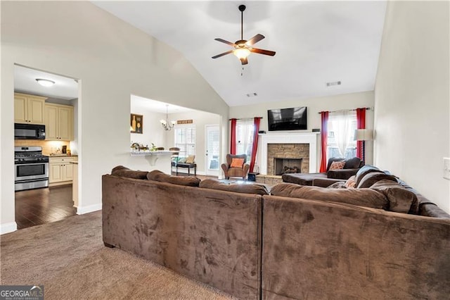 95 Summerlyn Dr, Hiram, GA 30141 - carpeted living room with a ceiling fan, plenty of natural light, a fireplace, high vaulted ceiling, and baseboards