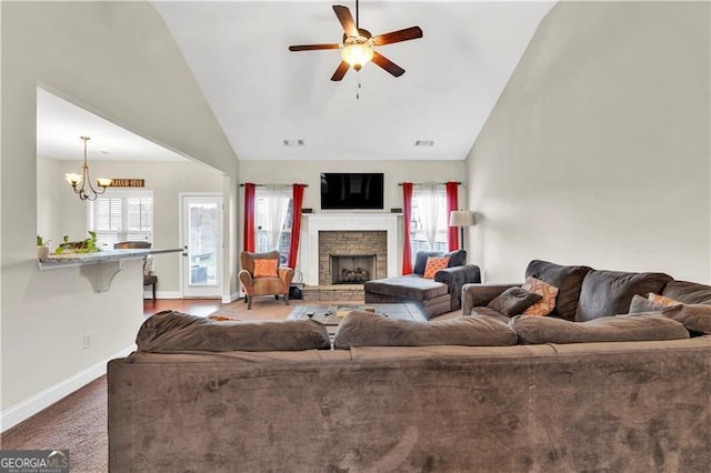 95 Summerlyn Dr, Hiram, GA 30141 - carpeted living room featuring lofted ceiling, a stone fireplace, ceiling fan, baseboards, and a chandelier