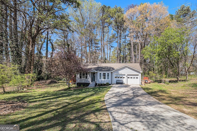 view of front of home with driveway, a garage, and a front lawn