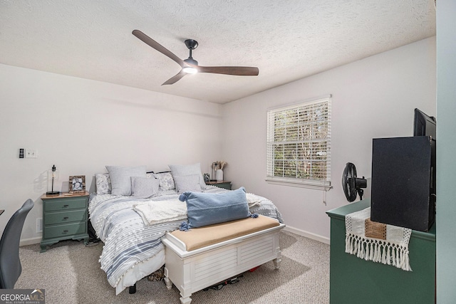 carpeted bedroom featuring a textured ceiling, baseboards, and ceiling fan