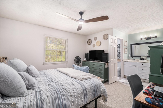 bedroom featuring a ceiling fan, a sink, light carpet, and a textured ceiling
