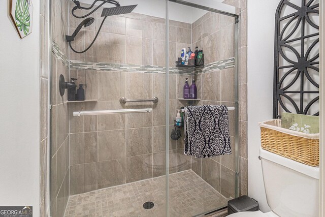 bathroom with a stall shower and toilet