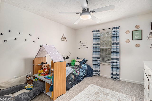 bedroom featuring baseboards, a textured ceiling, a ceiling fan, and light carpet