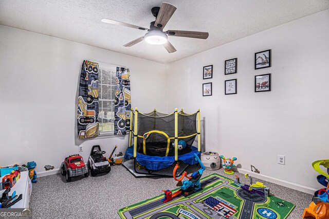 90 Chimney Rise Ct, Stockbridge, GA 30281 - game room featuring carpet floors, baseboards, a ceiling fan, and a textured ceiling