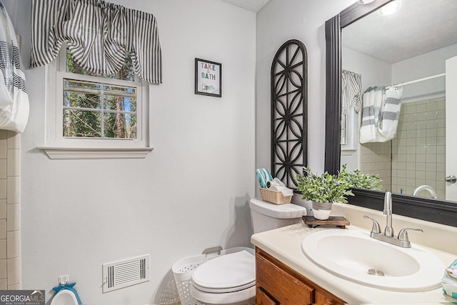 bathroom with visible vents, toilet, a shower with shower curtain, and vanity