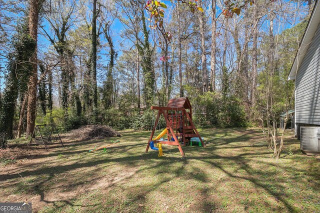90 Chimney Rise Ct, Stockbridge, GA 30281 - view of grassy yard featuring a playground and central air condition unit