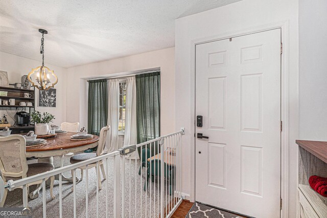 90 Chimney Rise Ct, Stockbridge, GA 30281 - dining room featuring a chandelier, wood finished floors, and a textured ceiling